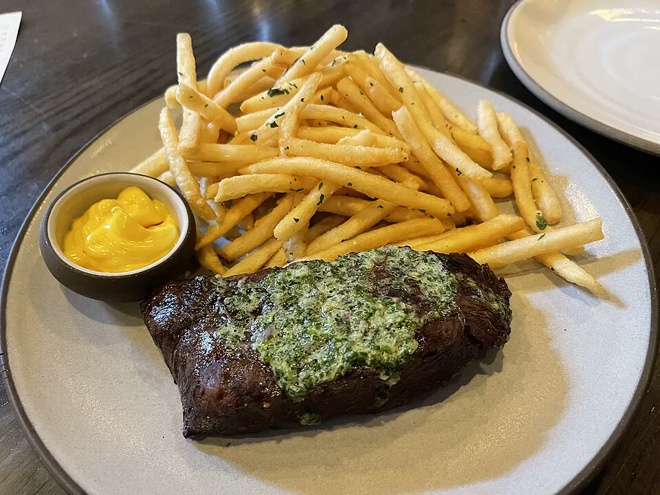 USDA Prime Ribeye Steak with Secret Herb Butter Sauce — signature food visual for La Vache! SoHo